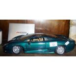 A Maisto 1/12 scale model of an XJ220 in green livery