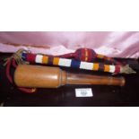 An American Indian beaded whip or dance stick together with a treen turned hardwood pestle