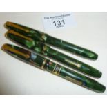 Three green marbled Conway Stewart Dinkie fountain pens with 14ct gold nibs, one with original