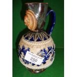 Doulton Stoneware jug with mask decoration by George Tinworth, 17cm