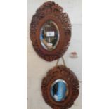 Pair oval Chinese carved openwork wood framed mirrors, 30cm x 22cm