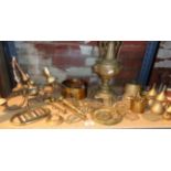 Shelf of assorted brassware, inc. horse brasses, table lamp, etc.