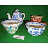 A Kutani tea bowl and saucer, two other bowls and a blue and white miniature teapot