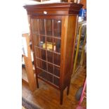 Tall narrow mahogany display cabinet with single glazed door having lattice mouldings