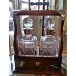 Silver mounted two bottle tantalus with silver mounted decanters