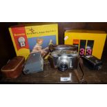 Braun Paxette camera, flash attachments, and a boxed Kodak Instamatic camera