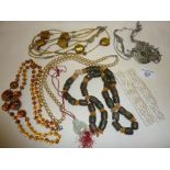 Chinese pierced bone purse handles with stylised dragons, assorted bead necklaces, inc. trade beads,