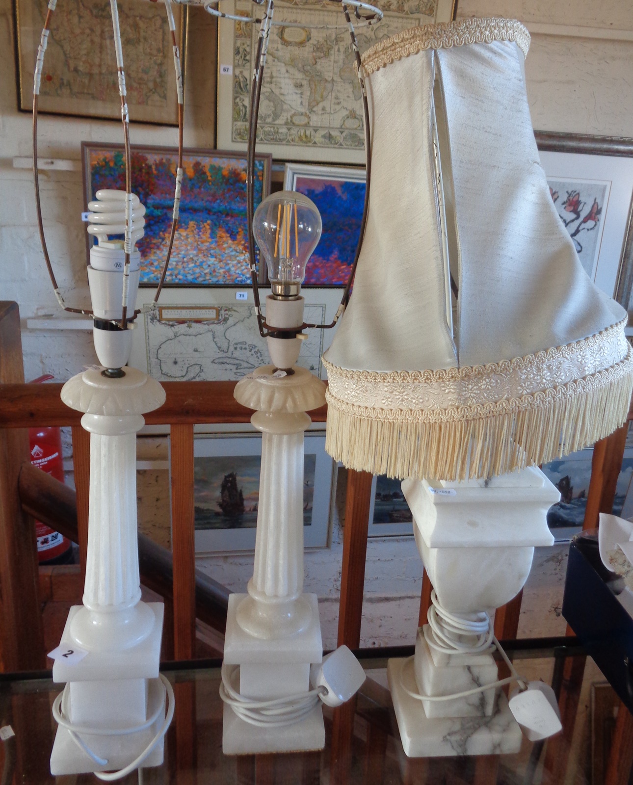 Two marble column table lamps and another