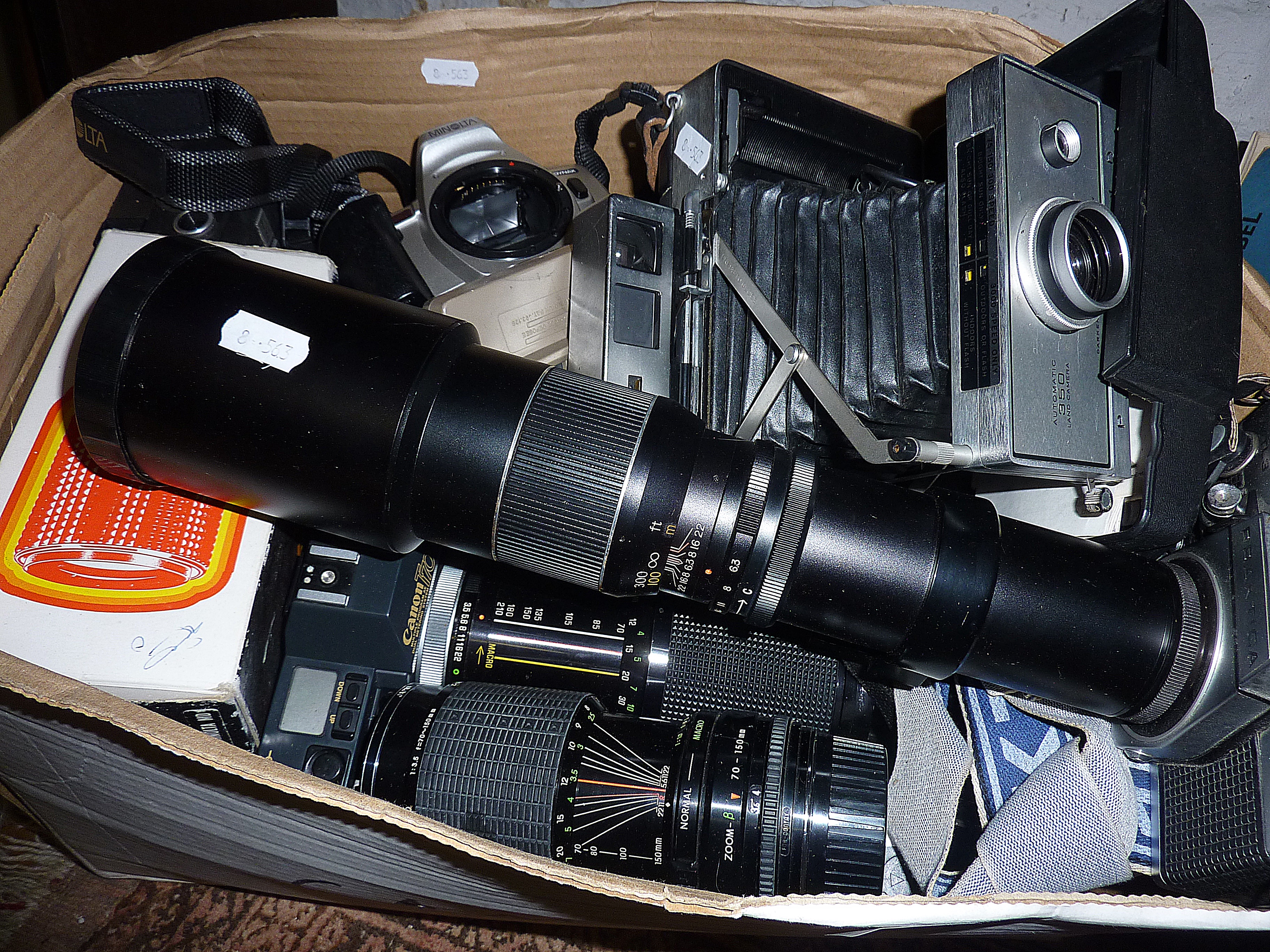 Box of assorted cameras and lenses