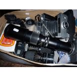 Box of assorted cameras and lenses