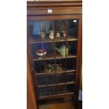 Tall narrow mahogany display cabinet with single glazed door having lattice mouldings