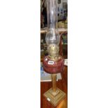 Victorian brass column oil lamp with cranberry glass reservoir