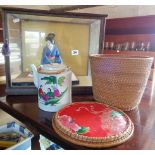 Glass cased Geisha tea girl doll, and a Chinese teapot in basket