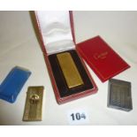 A Cartier gold plated gas lighter with box, an S. Dupont of Paris lighter and a gold plated cigar