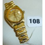 A replica Rolex Day-Date Oyster Perpetual wrist watch with gold dial and stick markers, Swiss