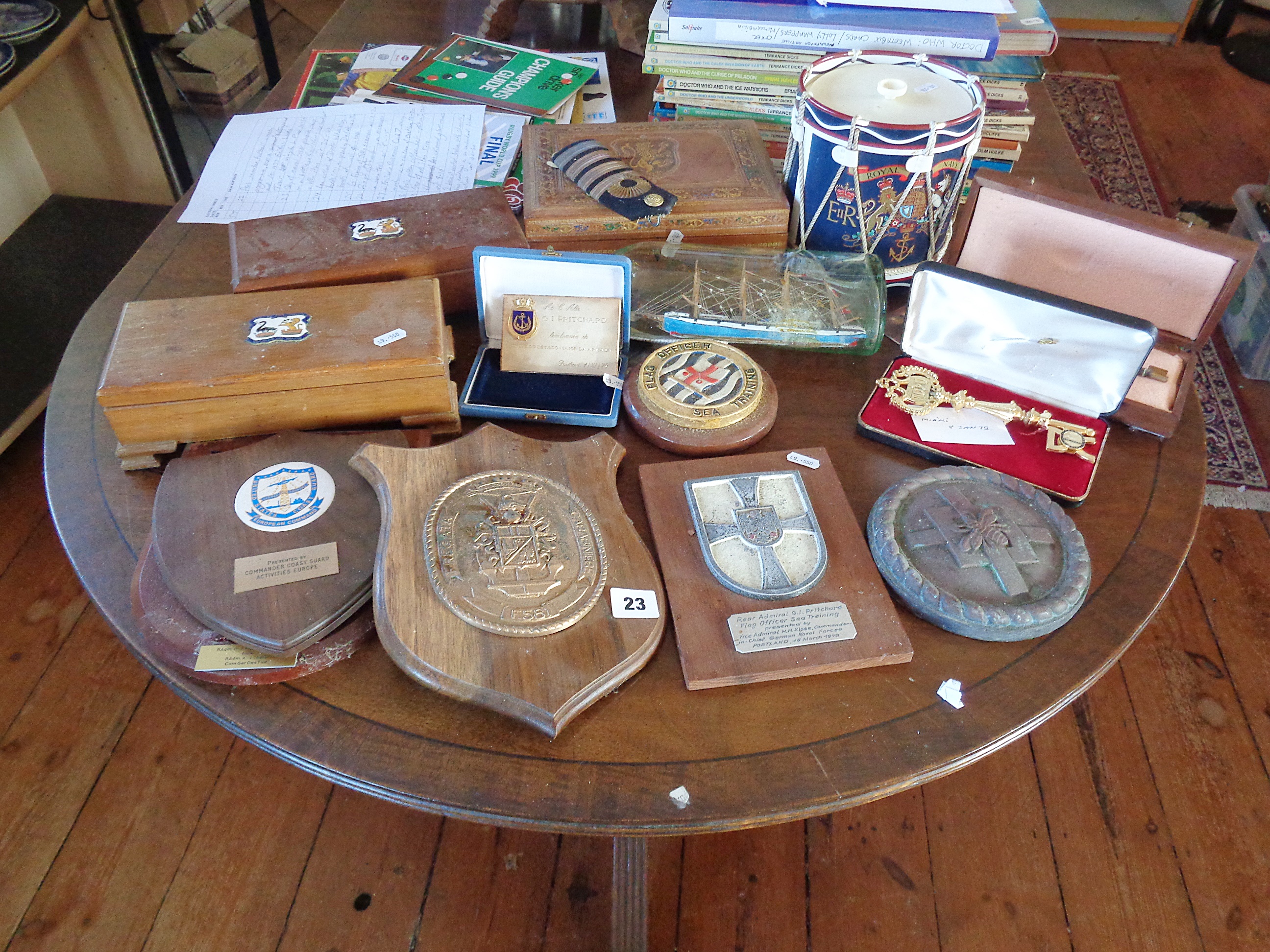 Quantity of naval crest plaques, ship in a bottle, a Royal Navy ice bucket and other items