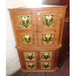 Two 2-door pine corner cabinets having Art Nouveau tile panels