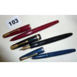 Three Parker fountain pens with gold nibs, a maroon Parker 17, a black Maxima Duofold and a blue