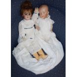 Two Victorian German bisque headed dolls in gowns