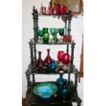 A collection of cranberry wine glasses, green glasses and a striated glass fruit bowl with two