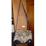 Vintage leather handbag with taxidermy face of leopard applied to body, circa 1930's