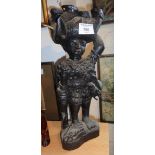 Tribal Art - African carved hardwood figure of a hunter carrying an elephant on his head, signed