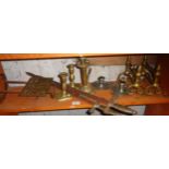 Various brass candlesticks, fire dogs, trivet and two souvenir swords