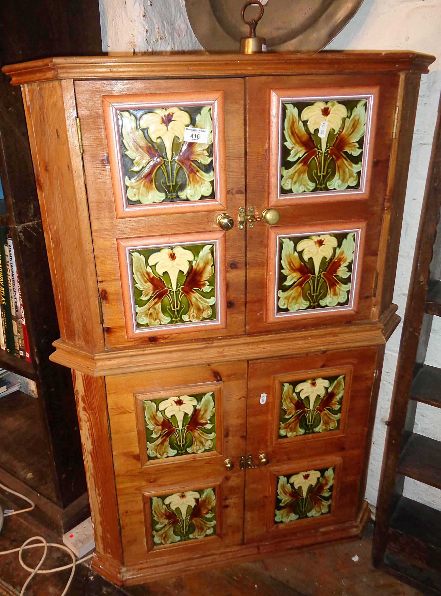 Pair of pine corner cupboards with Art Nouveau tile decoration