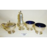 Silver four-piece cruet set with blue glass liners. Hallmarked for Birmingham 1929, approx 5oz