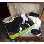 Large collection of assorted naval caps and uniform in a trunk