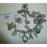 Hallmarked silver charm bracelet with many charms, some silver coloured metal