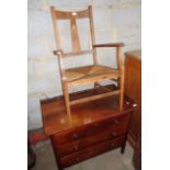 Chest of three drawers and a rush seat elbow chair