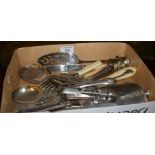 Box containing silver-plated cutlery and some lapel numbers