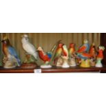 Shelf of brightly coloured 1930's Art Deco bird figurines, inc. a cockatiel by Markay Art Pottery
