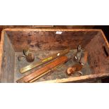 Old wooden crate with contents inc. blow torch, "boat" level, pair of brass spirit lamps etc.