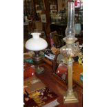 Tall Victorian brass column oil lamp with cut clear glass reservoir and another lamp