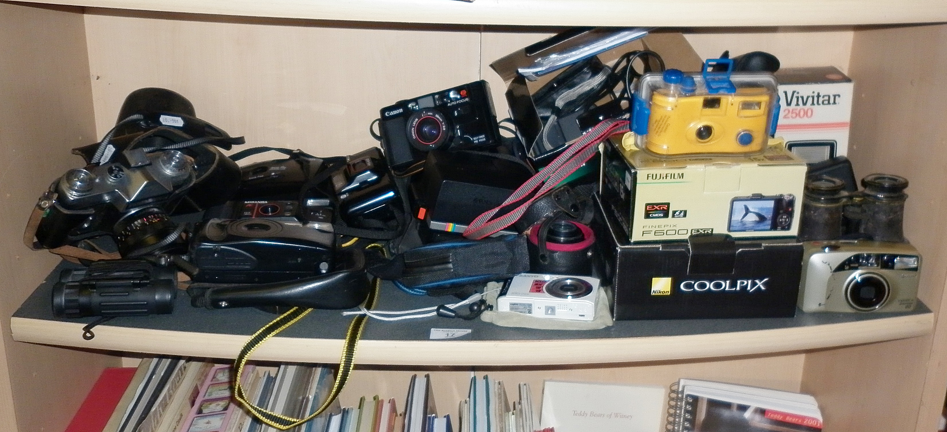 Shelf of assorted cameras and binoculars