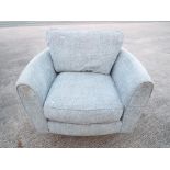An upholstered swivel chair This lot mus