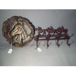 Two cast iron coat racks with an equestr