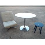 A modern circular table and a small occa