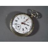 A white metal pocket watch with a Roman numerals, subsidiary dial,