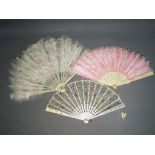 Three vintage fans, two feathered examples and one other.