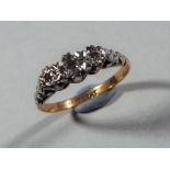 18 ct - 18 carat gold and platinum trilogy ring, approximate size M, approximate weight 2.35 g.