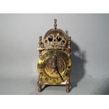 A small brass Smiths lantern style mantel clock with key.