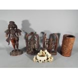 Four carved wooden items to include brush pot,