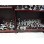A quantity of glassware, comprising decanters, wine glasses, branded glasses and similar.