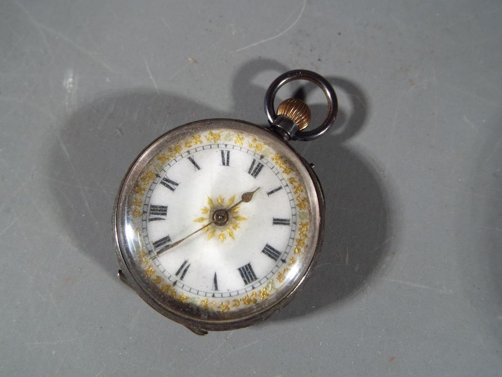 A Lady's silver pocket watch with ceramic dial with Roman numerals gilded highlights, stamped 925,