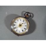 A Lady's silver pocket watch with ceramic dial with Roman numerals gilded highlights, stamped 925,