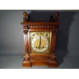 A large mantel or boardroom clock in an impressive mahogany case styled with influences of