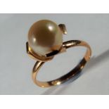 14 ct - A Lady's stamped yellow metal ring set with pearl, stamped mark unclear, presumed 14CT,